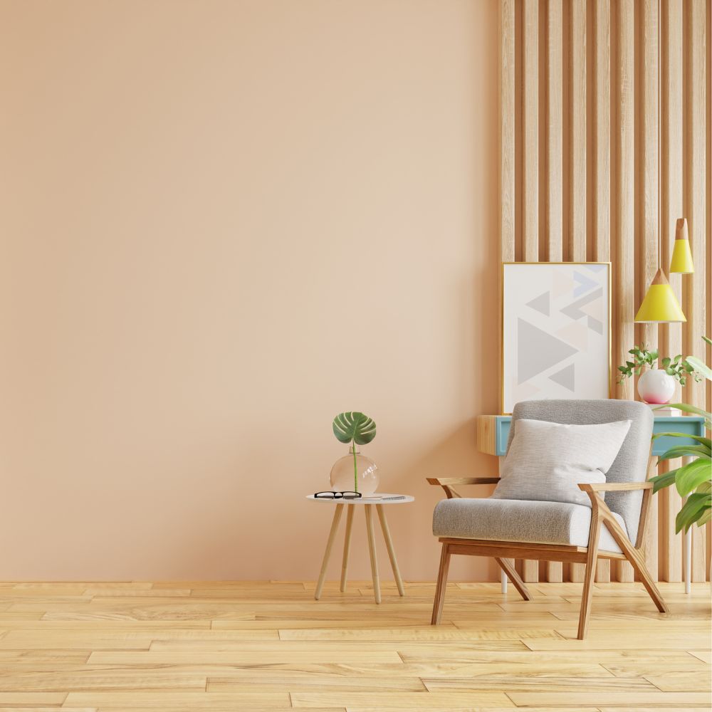 Cozy reading corner with peach accent wall and wood slat feature, freshly painted.