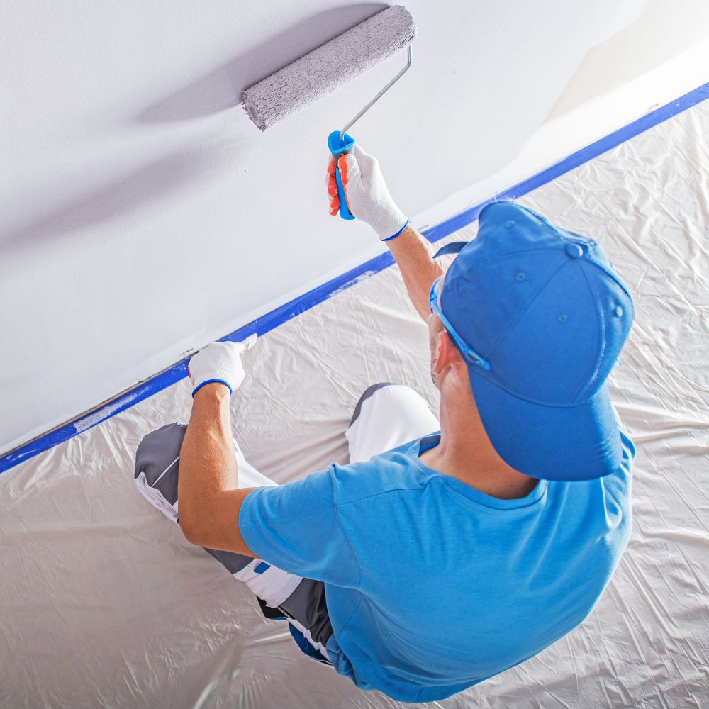 Professional painter rolling light-gray interior wall with Diamond Brite latex paint.